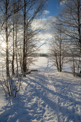 Winter wonderland scenery in Finland. Cold winter morning with snow and sunshine during sunrise