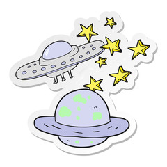sticker of a cartoon flying saucer and planet