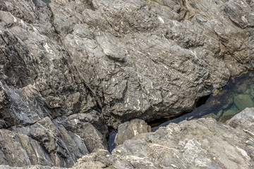 Italy, Cinque Terre, Manarola, CLOSE-UP OF ROCK FORMATION IN WATER