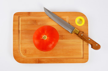 Knife and tomato on cutting board