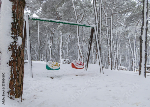 Empty Swings In Winter Time With Snow Stock Photo And