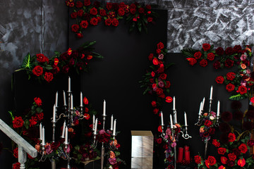 Roses on a black background. White candles.