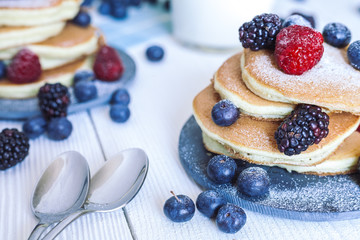 Delicious homemade pancakes with berries and milk