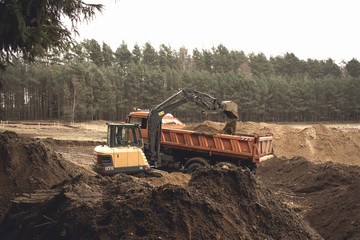 excavator loads lands