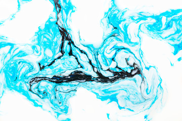 Abstract beautiful marbling with white and blue colors.The Eastern style of Ebru painting on water with acrylic paints swirls marbling.A stylish mix of natural luxury 