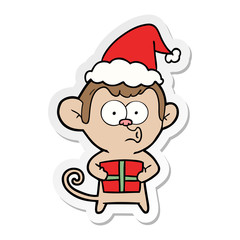 sticker cartoon of a christmas monkey wearing santa hat