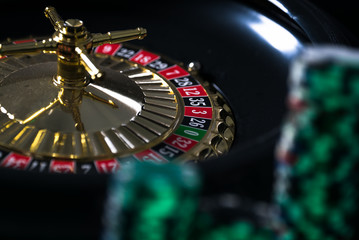  Casino background,  poker Chips on gaming table, roulette wheel in motion,