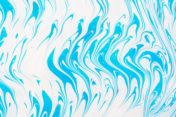 Fototapeta na wymiar Abstract beautiful marbling with white and blue colors.The Eastern style of Ebru painting on water with acrylic paints swirls marbling.A stylish mix of natural luxury 