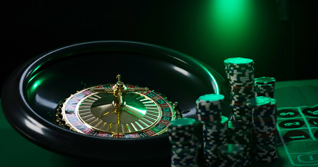  Casino background,  poker Chips on gaming table, roulette wheel in motion,