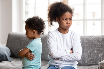 Stubborn little siblings avoid talking after fight - obrazy, fototapety, plakaty