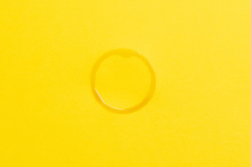 round trace of coffee on a yellow background