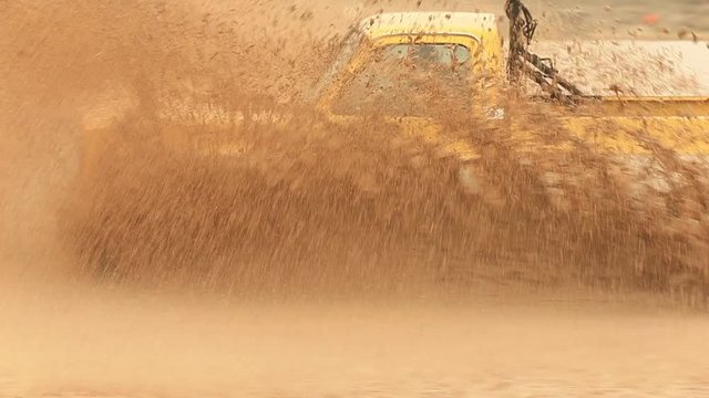 4x4 Pickup Truck Splashing Through Flooded Mud Bog.