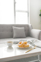Fototapeta na wymiar Classic donut. Morning breakfast on table in living room at home.