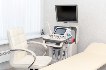 Interior of examination room with ultrasonography machine in hospital laboratory. Modern medical equipment background.