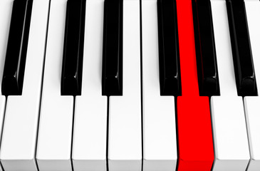 Top view of piano keys with one red button. Close-up of piano keys. Close frontal view. Piano keyboard with selective focus. Diagonal view. Piano keyboard perspective.