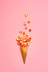 Flat lay : Ice cream cone with colorful party streamers on yellow background with copy space