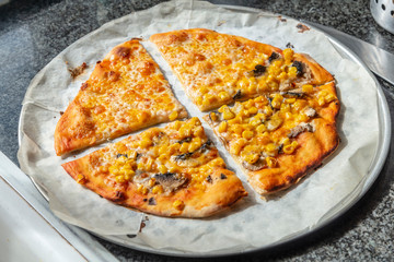 Homemade pizza with cheddar cheese and corn
