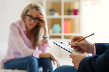 Woman meeting psychotherapist and discussing her problems