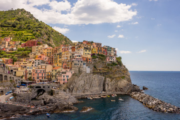 Fototapeta na wymiar Italy, Cinque Terre, Manarola, Cinque Terre, a large body of water with Cinque Terre in the background
