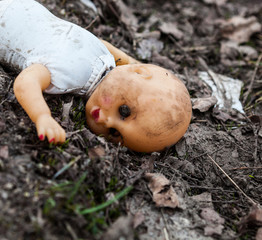 Old rejected dirty doll on the landfill