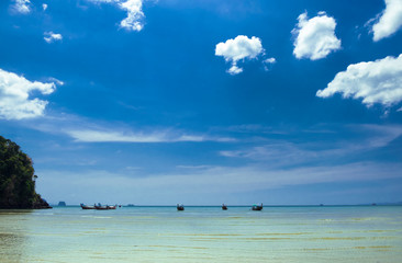 Thai traditional wooden boats on the beautiful beach in Krabi province. Thailand.
