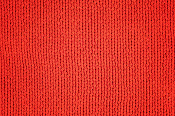 Red knitted woolen fabric as texture. Textile background
