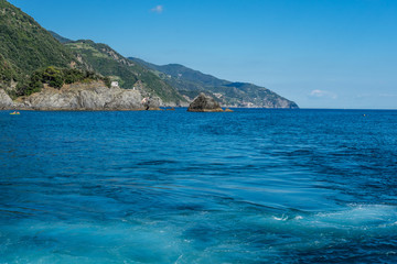 Fototapeta premium Italy, Cinque Terre, Monterosso, a body of water with a mountain in the background
