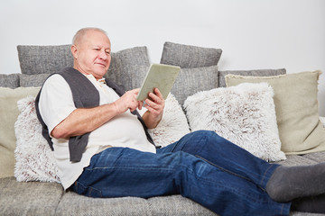 Fototapeta premium Man as senior relaxing at home