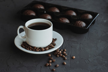 Obraz na płótnie Canvas Chocolate cakes and cup of coffee on dark background