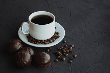 Chocolate cakes and cup of coffee on dark background