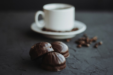 Chocolate cakes and cup of coffee on dark background