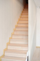 Concept of an interior modern beige stairway. Vertical. Front view, copy text.