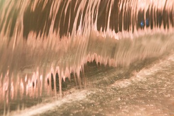 Abstract and close up of transparent falling water vertical flows.
