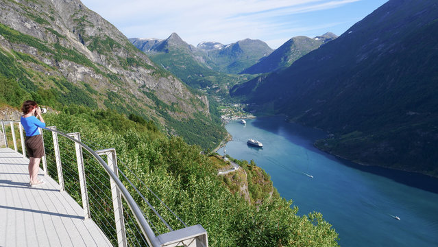 Tourist taking photo of fjord landscape, Norway © Voyagerix