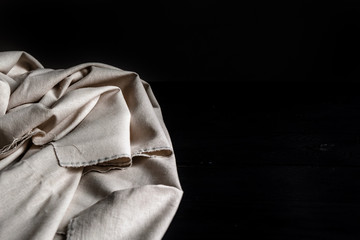 Textile fabric on table, black background, copy space