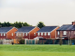 Obraz premium houses on a green field