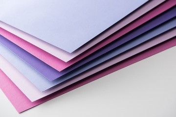 blank blue, white, pink and purple sheets of paper on white background