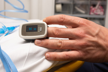 closeup of patient hand with pulsioximeter in hospital