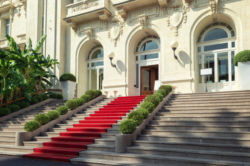 Fototapeta na wymiar The red carpet in front of the entrance of the famous Casino in San Remo