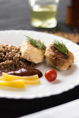 Chicken cutlets with buckwheat, herbs, ketchup and tomatoes