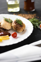 Chicken cutlets with buckwheat, herbs, ketchup and tomatoes