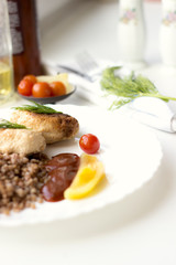 Chicken cutlets with buckwheat, herbs, ketchup and tomatoes