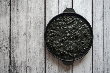 Black chili beans in a frying pan. Top view.