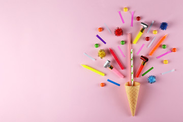 Birthday celebration attributes. Party horns, colorful confetti and other items on bright pink background. Close up, top view, copy space, flat lay.