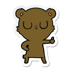 sticker of a peaceful cartoon bear cub