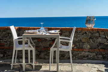 Italy, Cinque Terre, Monterosso, a group of lawn chairs sitting on top of a sandy beach