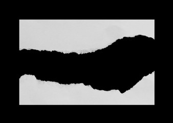 Piece of torn paper on black. Copy space
