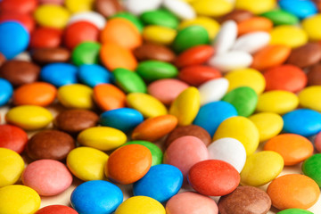 colored round candy scattered on the table close-up