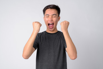 Fototapeta premium Portrait of young angry Asian man shouting and screaming