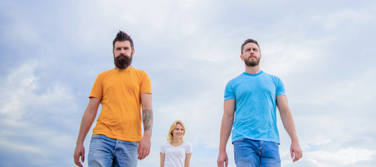 Casual inspired. Fashion people look casual in summer outfit. Pretty woman and men friends walking outdoor. Group of people in casual wear. Young people in casual style on cloudy sky